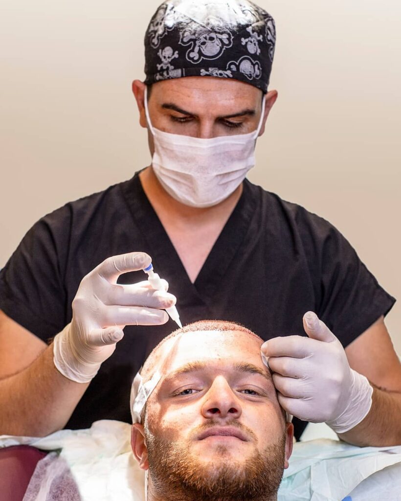 Dr Kinyas performing DHI Hair Transplantation